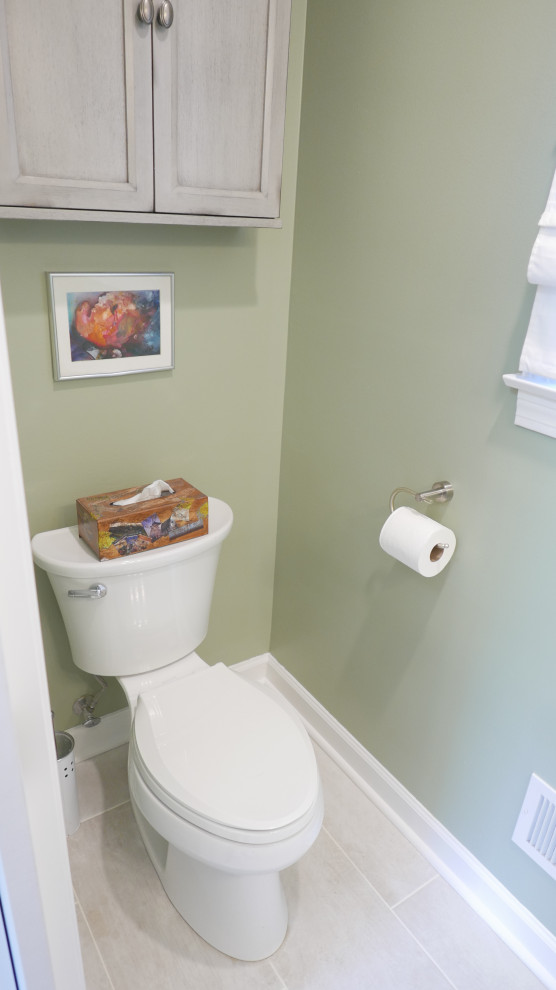 Kleine Klassische Gästetoilette mit Wandtoilette mit Spülkasten, grüner Wandfarbe, Porzellan-Bodenfliesen, Sockelwaschbecken und beigem Boden in Sonstige