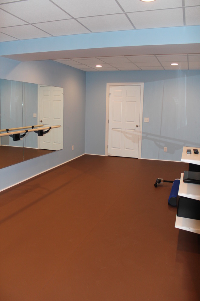 This is an example of a traditional home gym in Cleveland with blue walls.