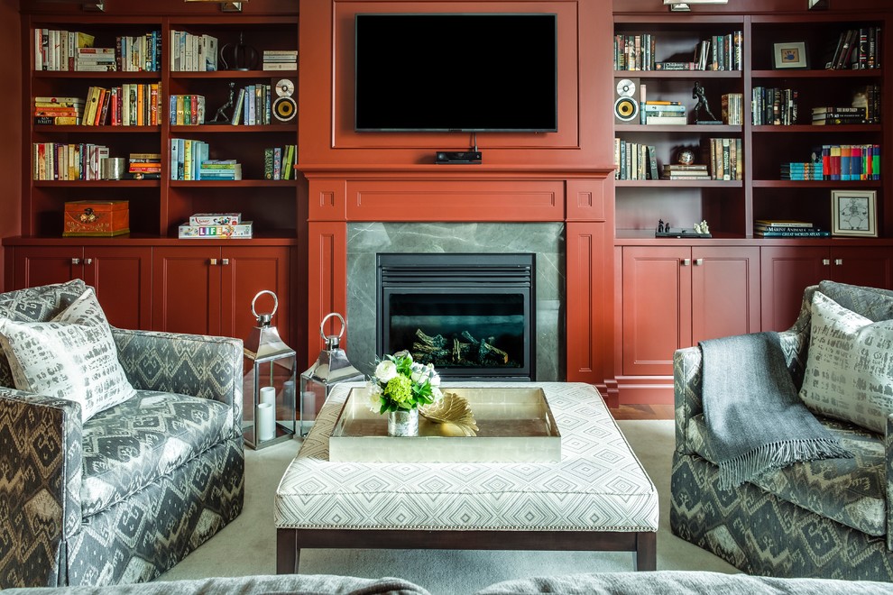 Design ideas for a transitional study room in Toronto with red walls, medium hardwood floors, a standard fireplace and a wood fireplace surround.