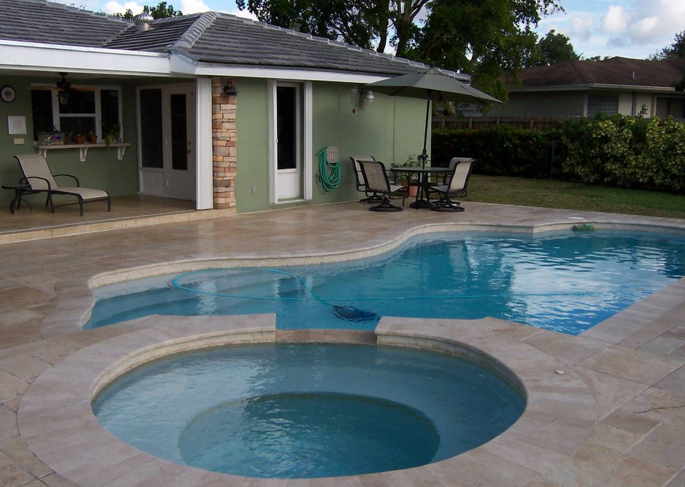 Transitional backyard tile and custom-shaped natural hot tub photo in Miami