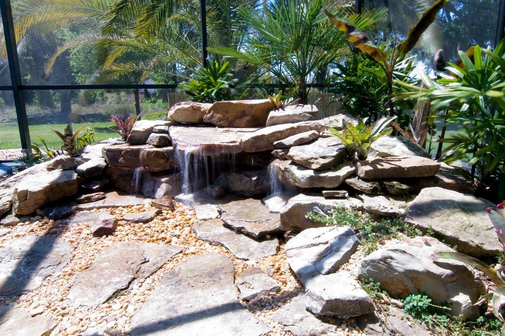 Photo of a large mediterranean full sun backyard gravel pond in Jacksonville.