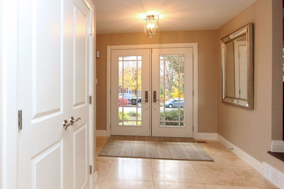 Inspiration for a large transitional porcelain tile and multicolored floor front door remodel with beige walls and a white front door