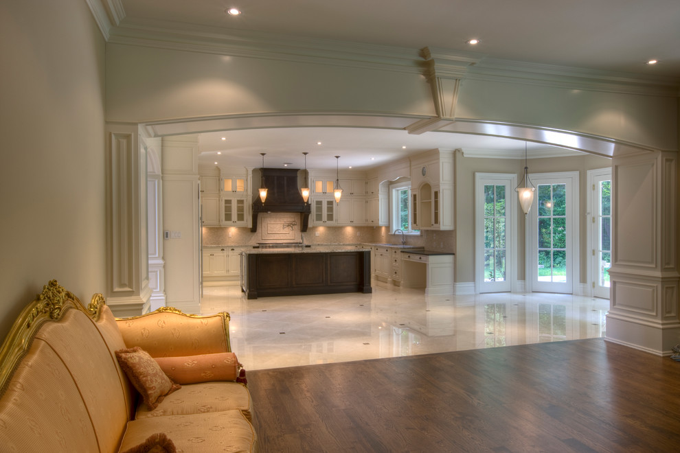 Inspiration for a large transitional u-shaped porcelain tile and white floor home design remodel in Toronto with an undermount sink, shaker cabinets, white cabinets, granite countertops, beige backsplash, mosaic tile backsplash, stainless steel appliances and an island