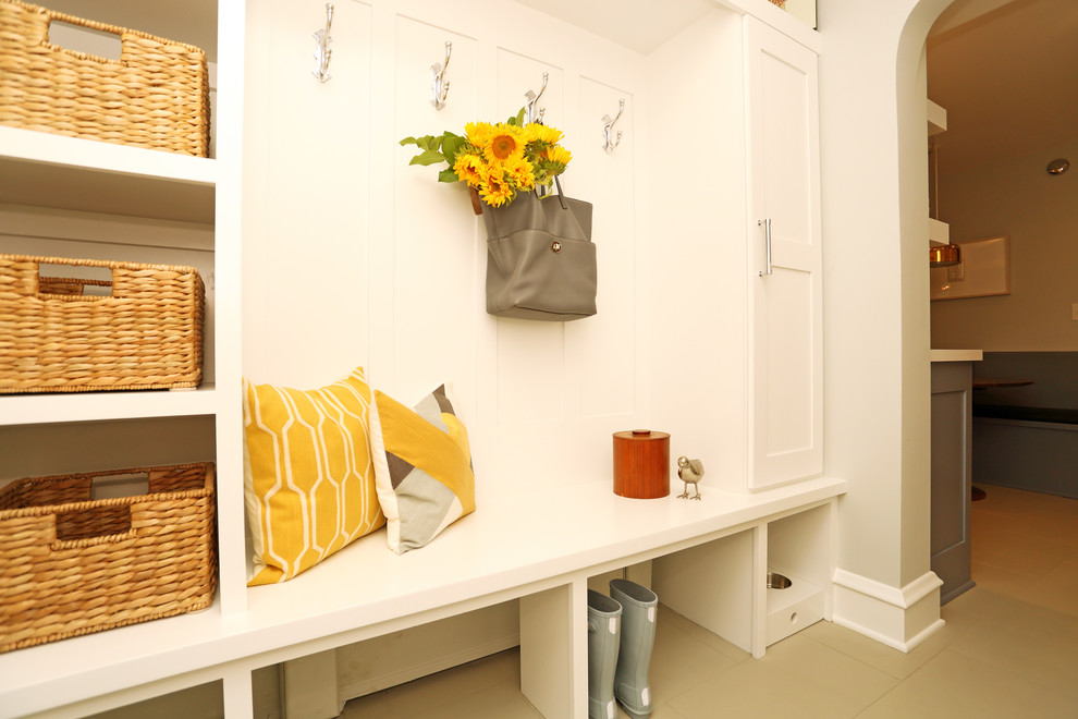 Inspiration for a mid-sized transitional mudroom in Milwaukee with white walls and ceramic floors.