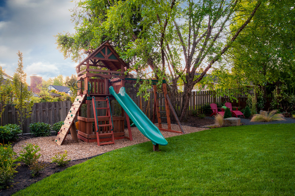 This is an example of a traditional garden in Portland with with outdoor playset.