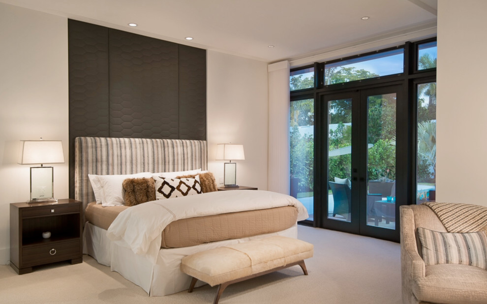 Mid-sized contemporary guest bedroom in Miami with beige walls and carpet.