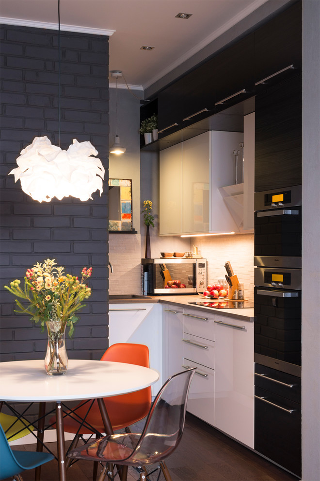 Photo of a contemporary l-shaped open plan kitchen in Moscow with a drop-in sink, flat-panel cabinets, white cabinets, stainless steel appliances and no island.