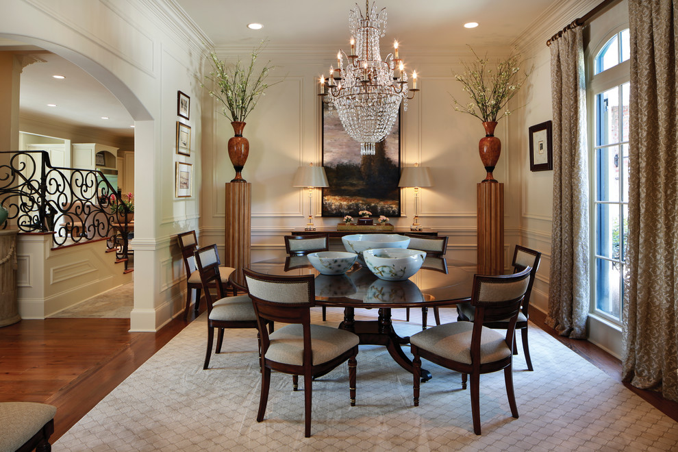 Enclosed dining room - traditional dark wood floor enclosed dining room idea in New Orleans with beige walls and no fireplace