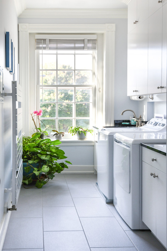 Dedicated laundry room - small traditional single-wall porcelain tile and gray floor dedicated laundry room idea in Richmond with an undermount sink, flat-panel cabinets, white cabinets, granite countertops, blue walls, a side-by-side washer/dryer and blue countertops