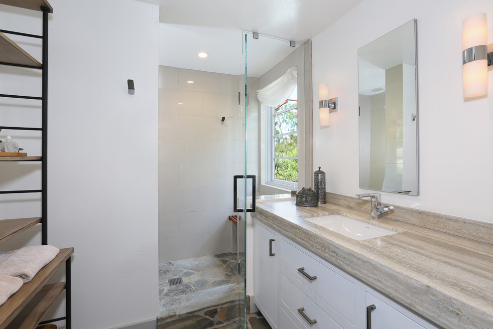 Inspiration for a beach style bathroom in Orange County with an undermount sink, flat-panel cabinets, white cabinets, granite benchtops, a freestanding tub, an alcove shower, glass tile, white walls and slate floors.