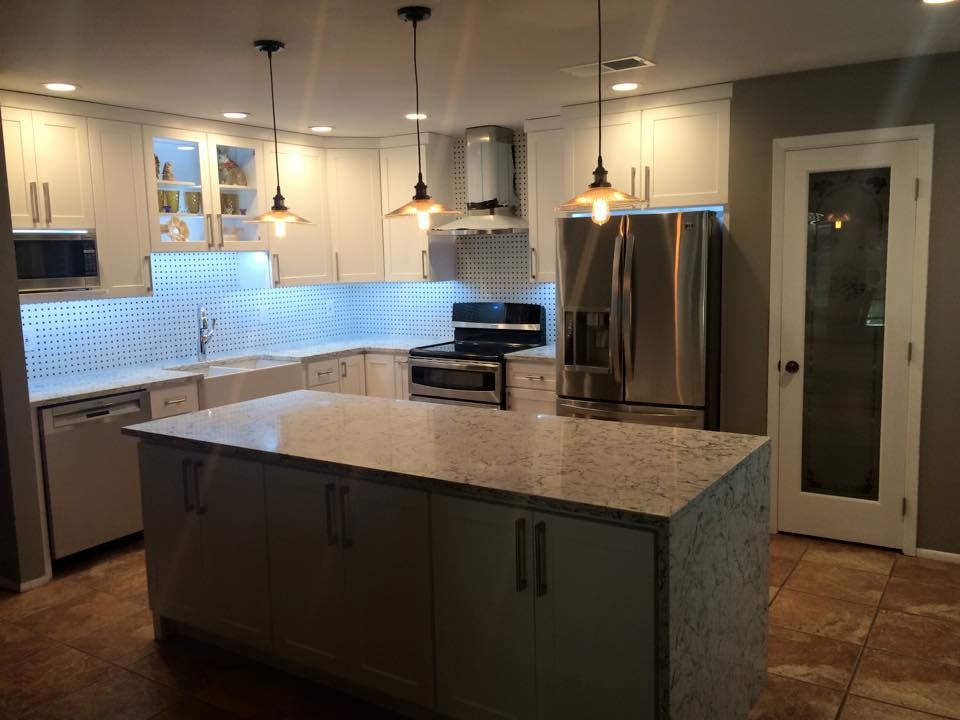 Open concept kitchen - mid-sized transitional u-shaped ceramic tile and beige floor open concept kitchen idea in Austin with a farmhouse sink, shaker cabinets, white cabinets, granite countertops, multicolored backsplash, porcelain backsplash, stainless steel appliances and an island