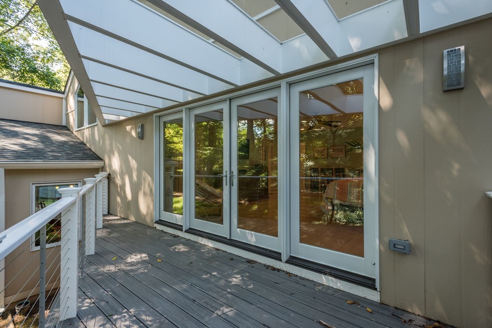Inspiration for a mid-sized midcentury side yard deck in DC Metro with a pergola.