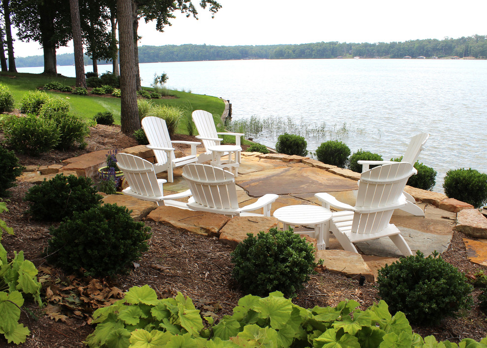 Inspiration for a beach style backyard patio in DC Metro with natural stone pavers and no cover.