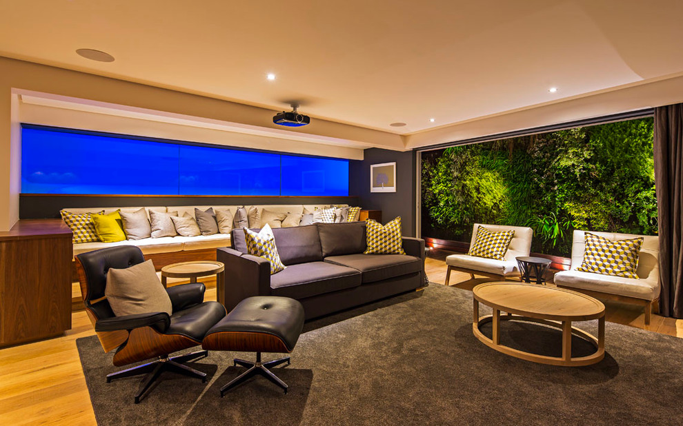 Contemporary enclosed home theatre in Other with light hardwood floors and a projector screen.