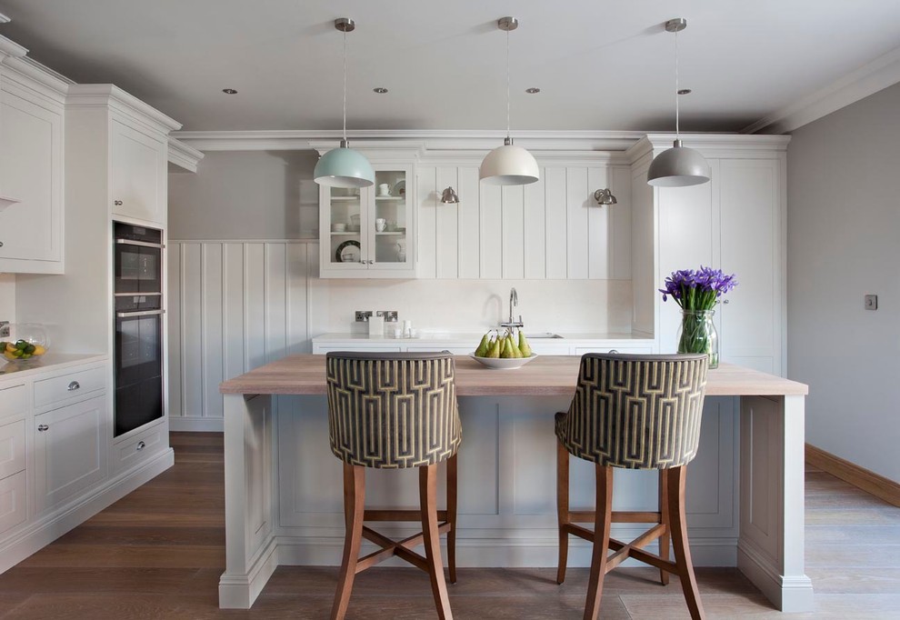 Inspiration for a classic l-shaped kitchen in Dublin with wood worktops, light hardwood flooring and an island.
