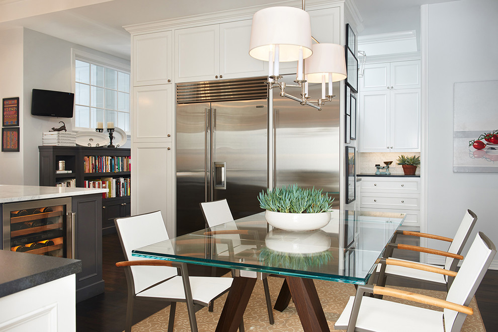 Large transitional dark wood floor eat-in kitchen photo in Los Angeles with an undermount sink, recessed-panel cabinets, white cabinets, granite countertops, white backsplash, stone tile backsplash, stainless steel appliances and an island