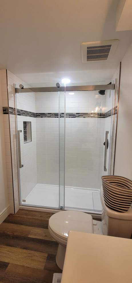Mid-sized kids' white tile vinyl floor, brown floor and single-sink bathroom photo with brown cabinets
