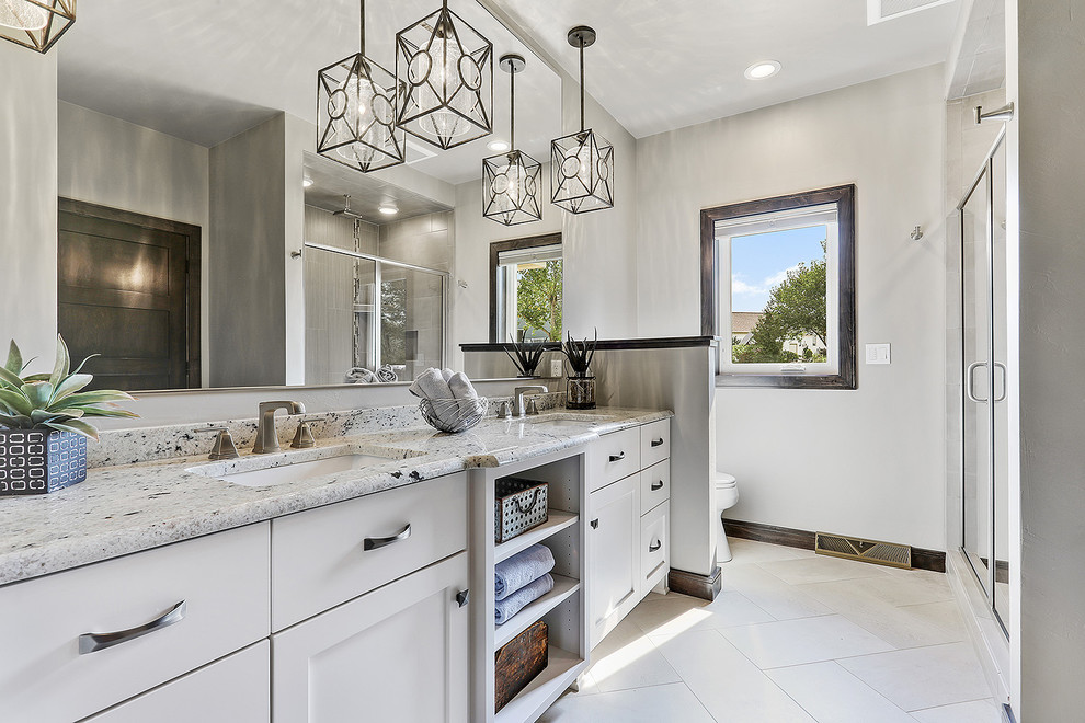 Alcove shower - mid-sized transitional master gray tile and porcelain tile vinyl floor and white floor alcove shower idea with flat-panel cabinets, white cabinets, an undermount sink, quartzite countertops, a hinged shower door and gray walls