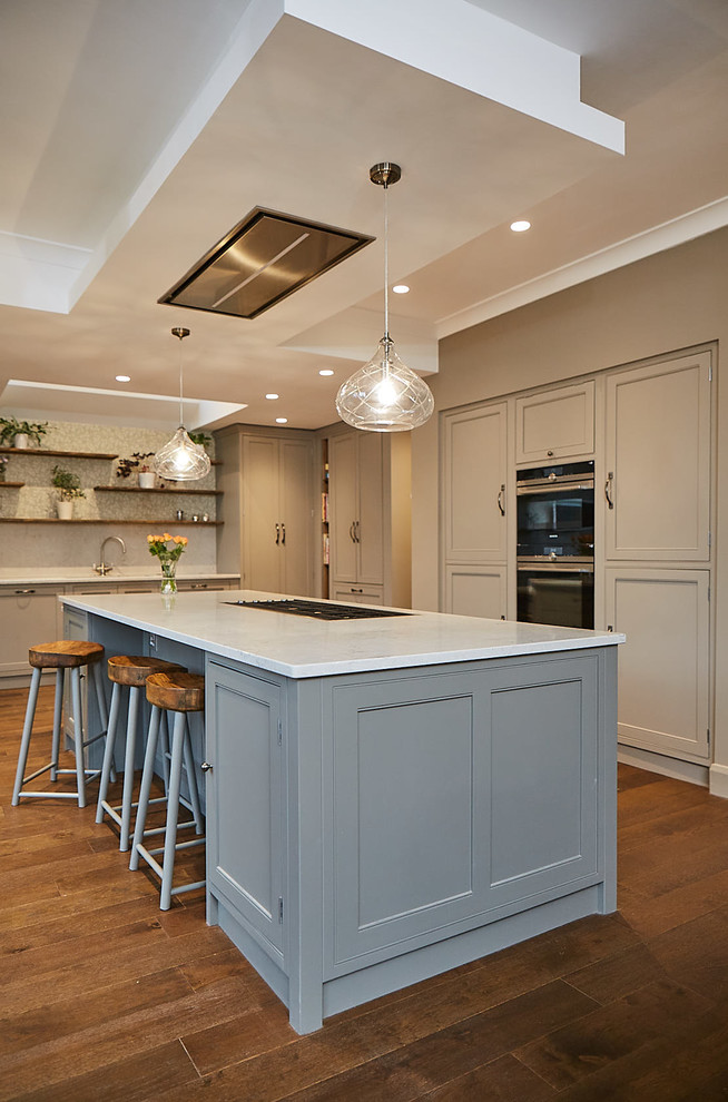 Photo of a large traditional open plan kitchen in Other with shaker cabinets, beige cabinets, granite benchtops, beige splashback, with island and beige benchtop.