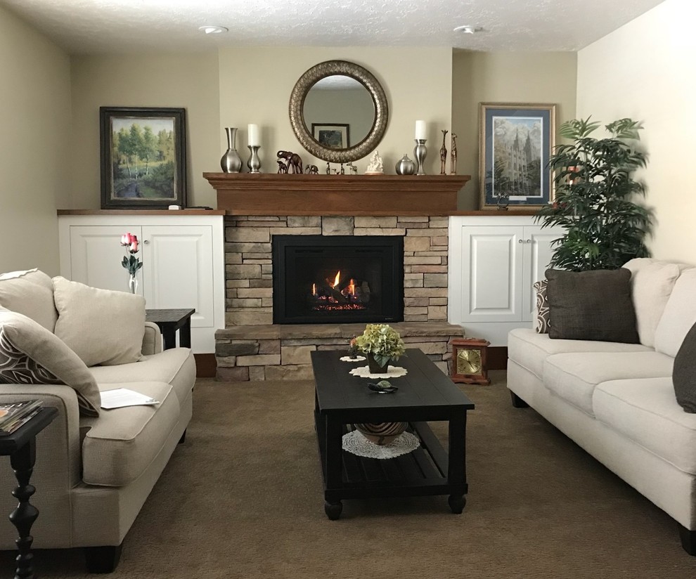 Photo of a mid-sized traditional living room in Salt Lake City with beige walls, carpet, a standard fireplace, a stone fireplace surround, no tv and beige floor.