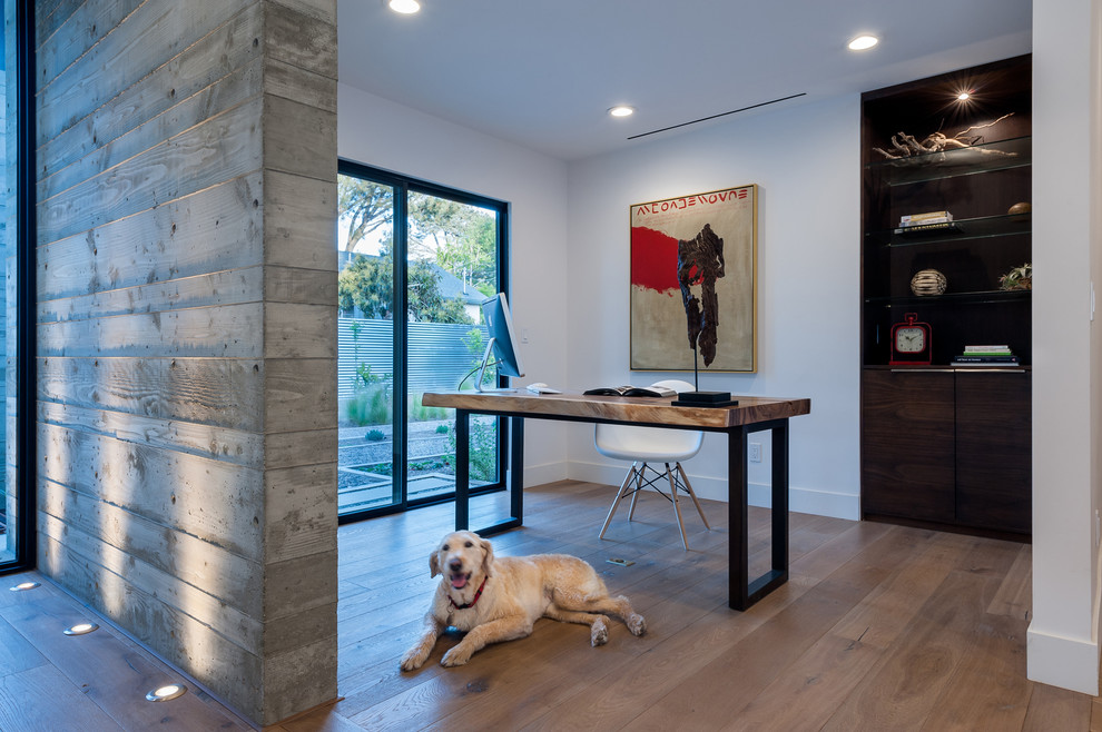 Mid-sized contemporary home office in San Diego with white walls, medium hardwood floors and a freestanding desk.