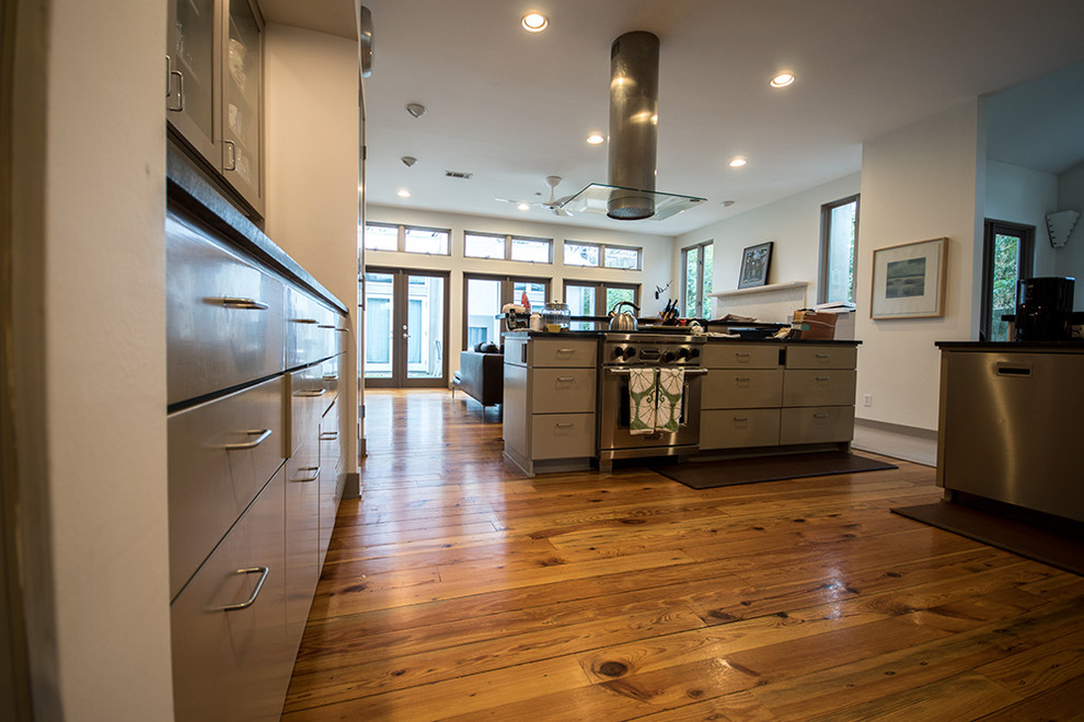 Photo of a contemporary kitchen in Austin with light hardwood floors.