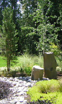 This is an example of a mid-sized country front yard partial sun formal garden in Seattle with with rock feature.