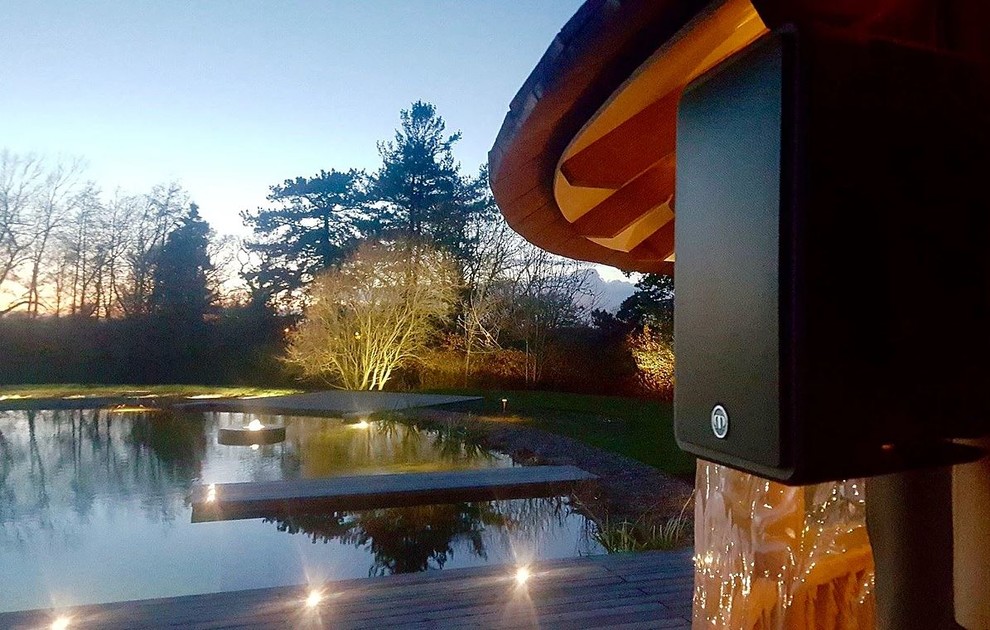 This is an example of a large country backyard pool in Cheshire with decking.