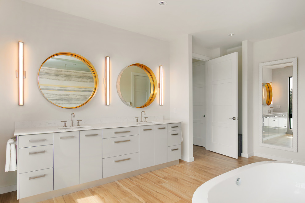 Inspiration for a mid-sized modern master bathroom in Tampa with flat-panel cabinets, grey cabinets, a freestanding tub, a curbless shower, a bidet, yellow tile, porcelain tile, white walls, porcelain floors, an undermount sink, engineered quartz benchtops, brown floor and white benchtops.