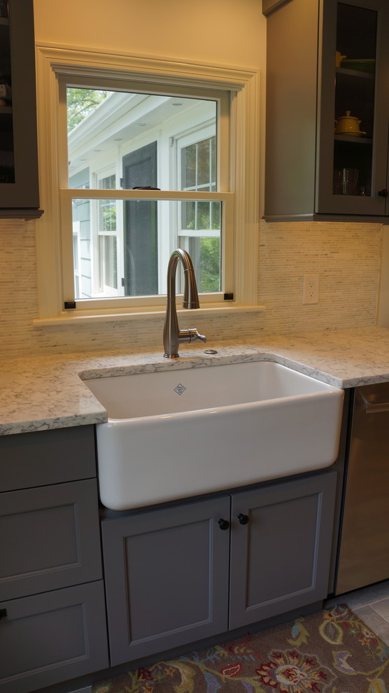 Inspiration for a mid-sized transitional galley porcelain tile and gray floor open concept kitchen remodel in Boston with a farmhouse sink, recessed-panel cabinets, quartz countertops, white backsplash, porcelain backsplash, stainless steel appliances, an island and white countertops
