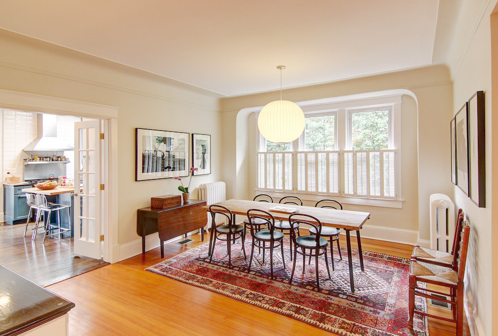 Design ideas for an eclectic dining room in DC Metro with beige walls and medium hardwood floors.