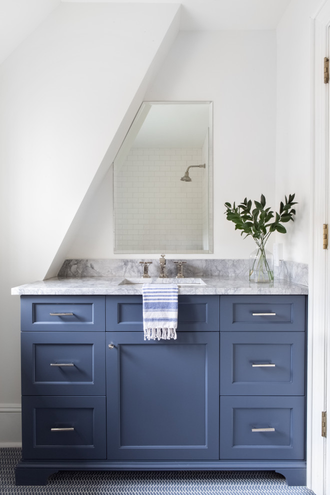 Photo of an expansive transitional 3/4 bathroom in New York with blue floor, marble floors, shaker cabinets, blue cabinets, white tile, subway tile, white walls, an undermount sink and grey benchtops.
