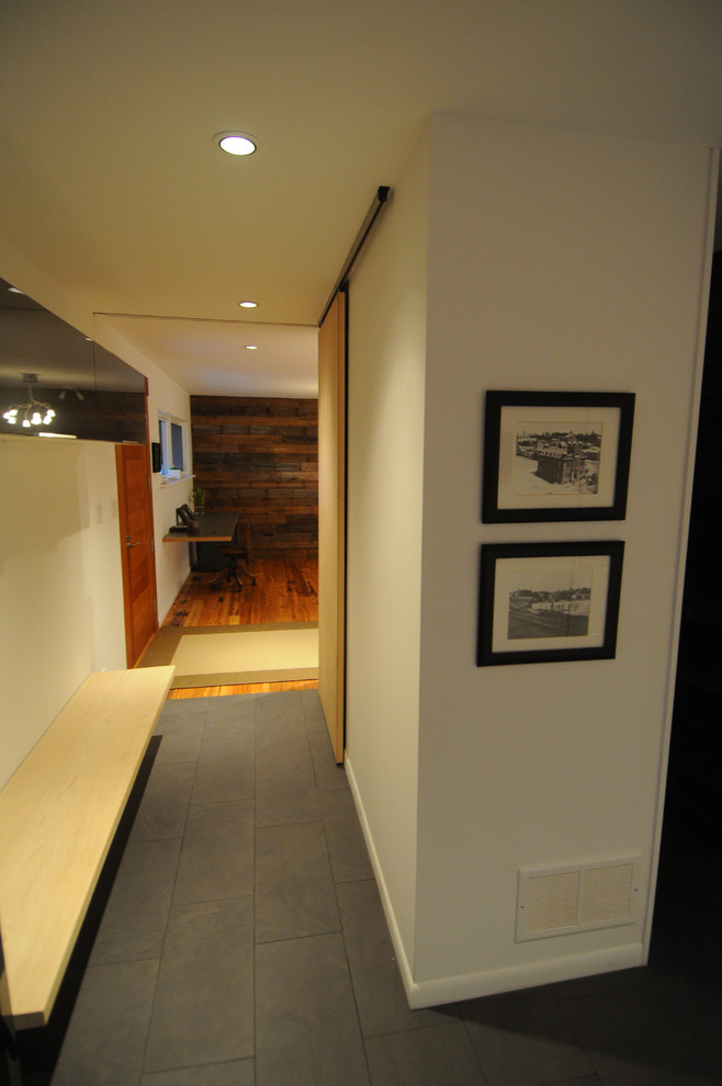 This is an example of a mid-sized contemporary hallway in Toronto with grey walls and ceramic floors.