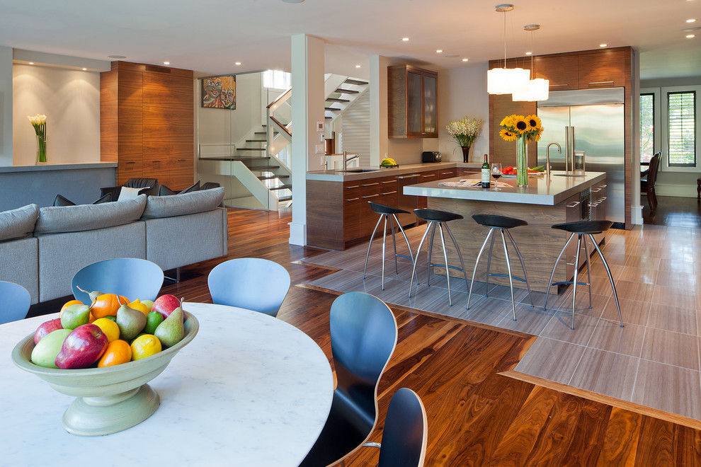 Photo of a contemporary kitchen in Toronto with stainless steel appliances and brown floor.