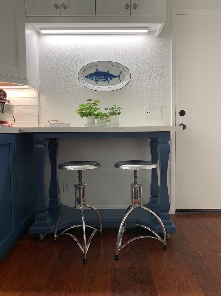 Example of a mid-sized transitional galley medium tone wood floor and red floor kitchen design with a single-bowl sink, shaker cabinets, white cabinets, quartz countertops, white backsplash, cement tile backsplash, stainless steel appliances, no island and white countertops