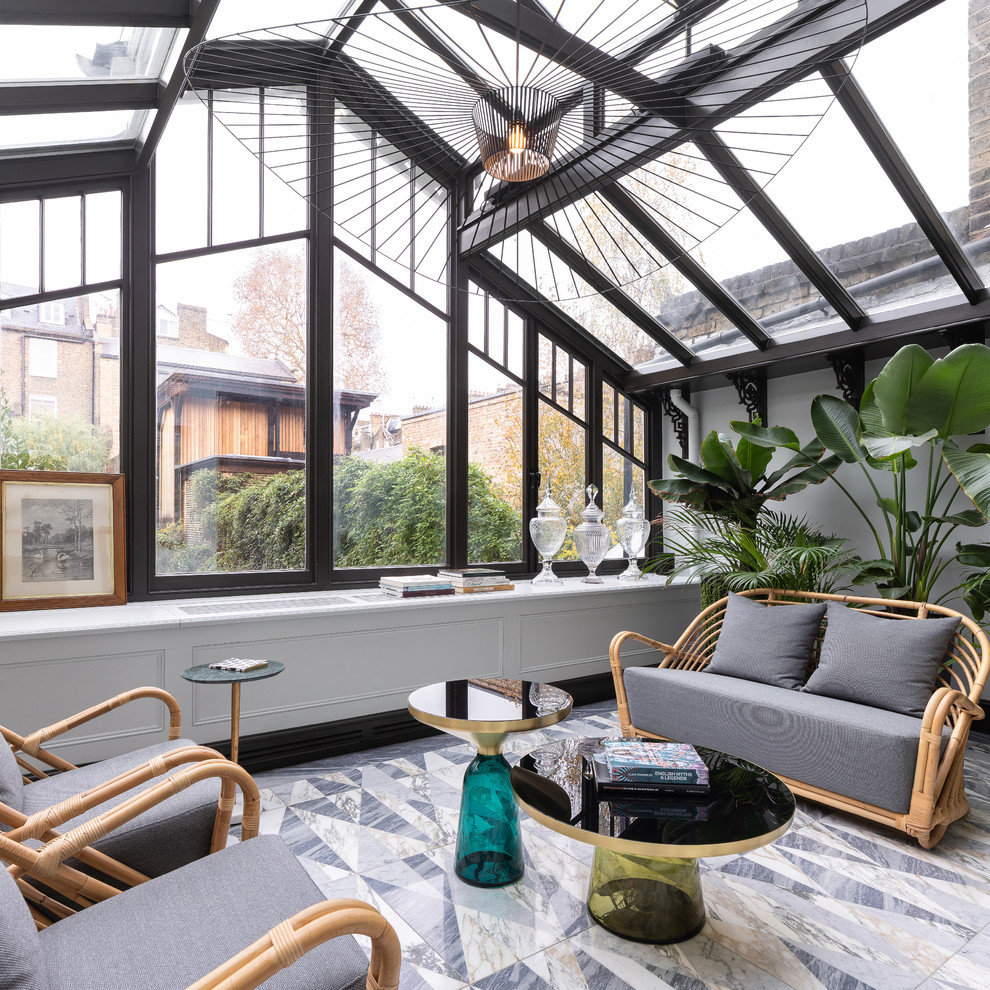 Inspiration for a transitional sunroom in London with no fireplace, a glass ceiling and grey floor.