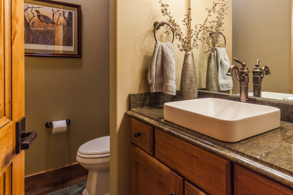 Bathroom - mid-sized rustic 3/4 dark wood floor bathroom idea with beaded inset cabinets, medium tone wood cabinets, beige walls, a vessel sink and granite countertops