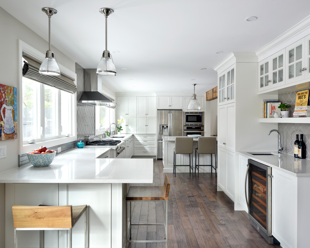 Kitchen - transitional kitchen idea in Toronto with an undermount sink, shaker cabinets, white cabinets, gray backsplash, stainless steel appliances and an island
