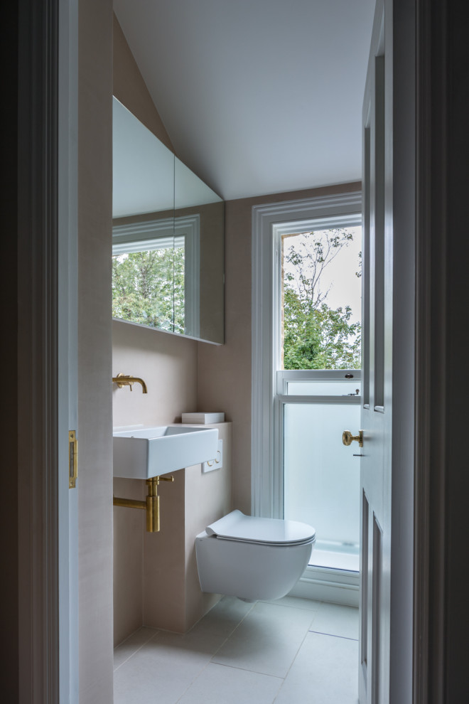 This is an example of a mid-sized modern kids bathroom in Essex with an open shower, a wall-mount toilet, pink tile, pink walls, ceramic floors, a wall-mount sink, solid surface benchtops, grey floor, an open shower and pink benchtops.