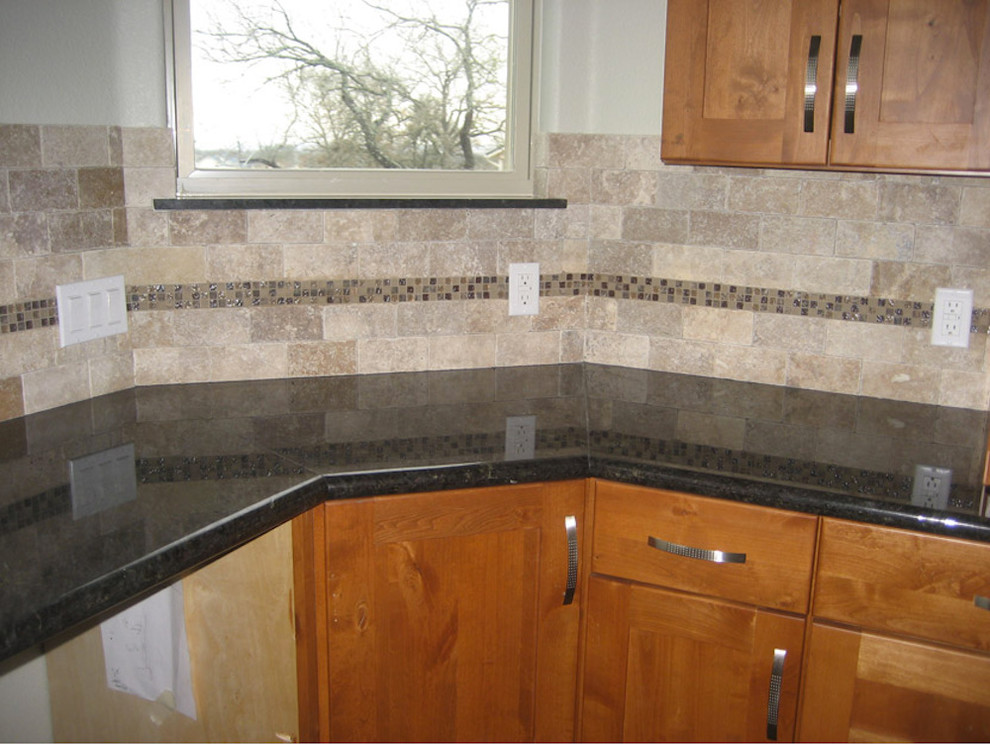 Inspiration for a mid-sized transitional u-shaped enclosed kitchen remodel in Austin with an island, shaker cabinets, light wood cabinets, beige backsplash, stone tile backsplash and stainless steel appliances