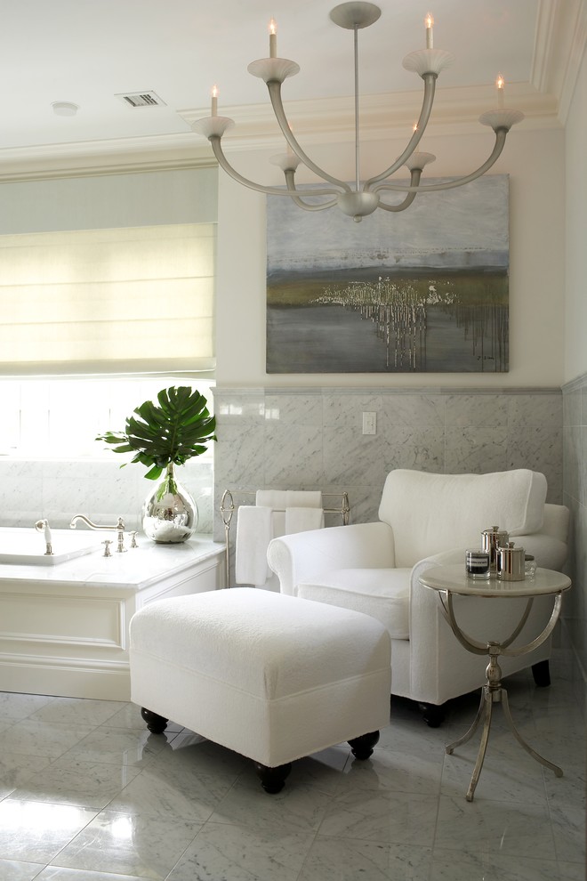 Transitional bathroom in New York with a drop-in tub, white tile and white walls.