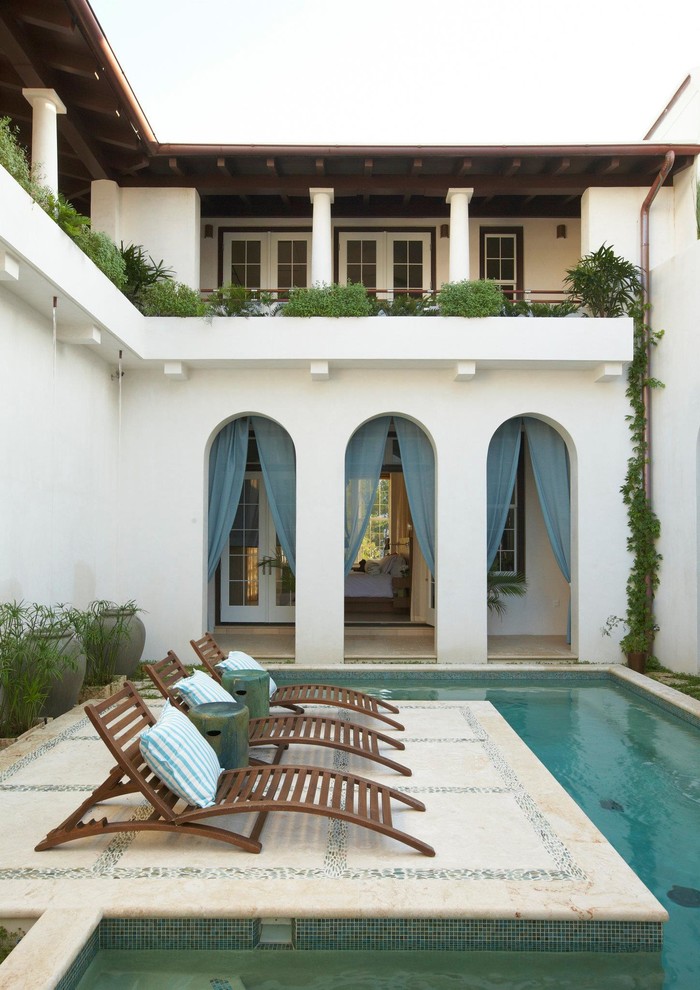Design ideas for a mediterranean courtyard custom-shaped pool in Miami.