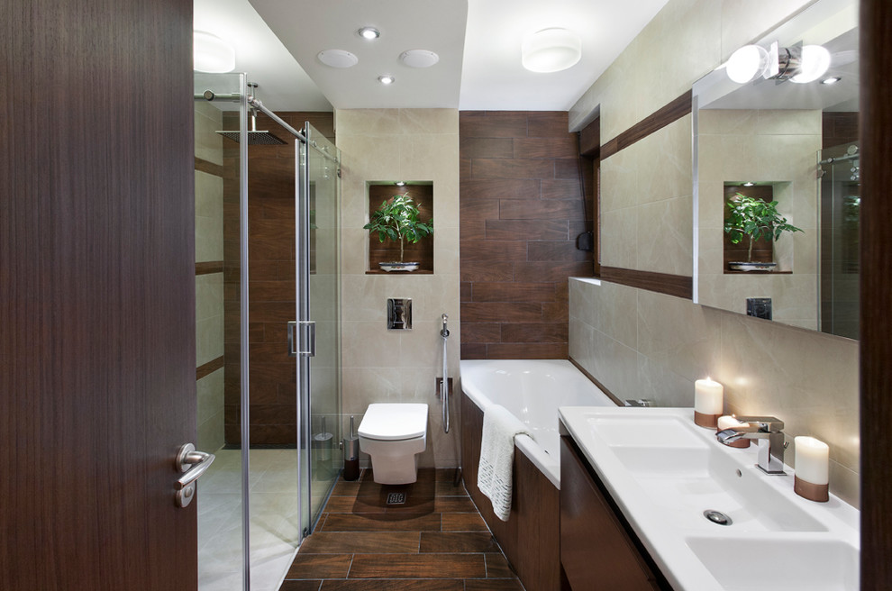 Corner bathtub - mid-sized contemporary master beige tile and ceramic tile ceramic tile corner bathtub idea with flat-panel cabinets, dark wood cabinets, a wall-mount toilet, beige walls and a pedestal sink