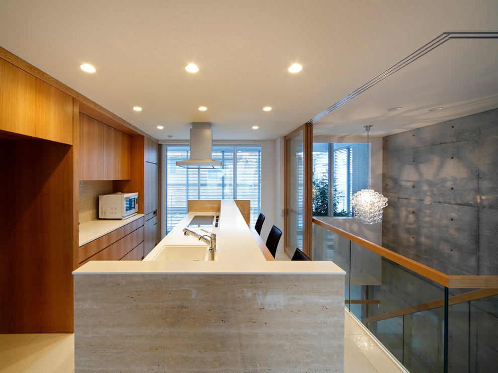 Inspiration for a contemporary single-wall open plan kitchen in Osaka with an integrated sink, flat-panel cabinets, medium wood cabinets, solid surface benchtops, stainless steel appliances, porcelain floors, with island, white floor and white benchtop.