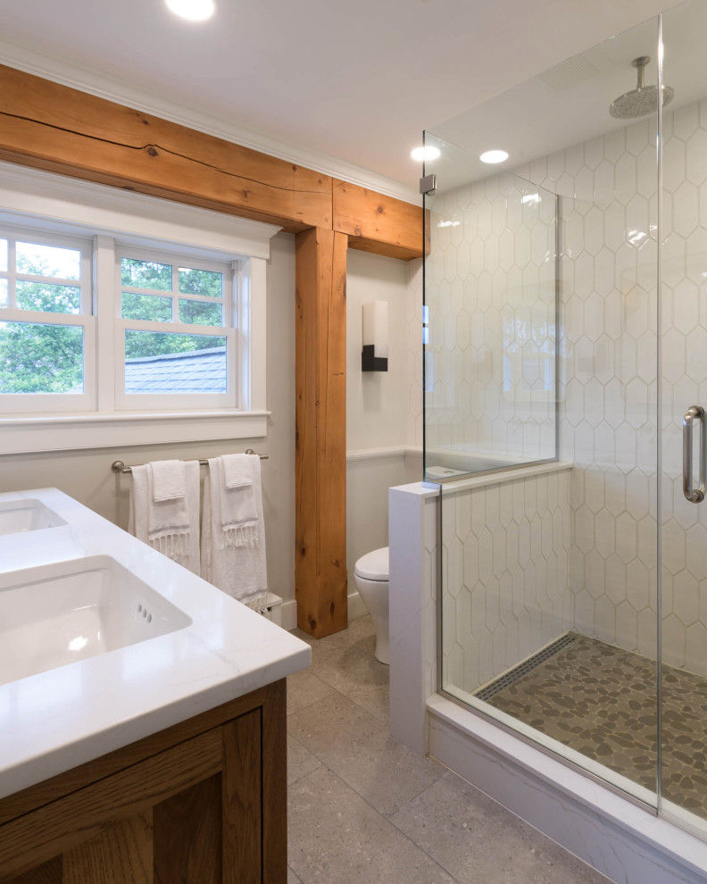 This is an example of a transitional bathroom in Burlington with brown cabinets, grey walls, porcelain floors, a vessel sink, engineered quartz benchtops, grey floor, white benchtops, a single vanity and a built-in vanity.
