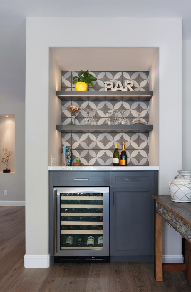 Design ideas for a transitional home bar in Orange County.