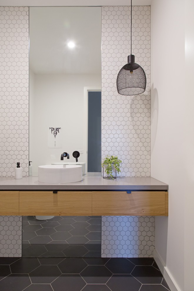Inspiration for a contemporary powder room in Melbourne with grey benchtops.