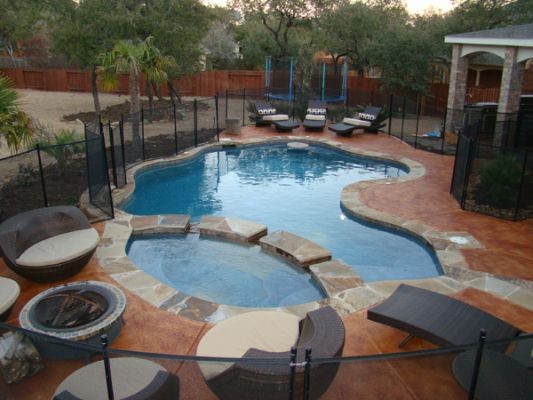 Pool - rustic backyard custom-shaped pool idea in Austin