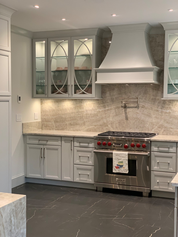 Mid-sized transitional l-shaped separate kitchen in New York with an undermount sink, flat-panel cabinets, grey cabinets, quartzite benchtops, beige splashback, stone slab splashback, stainless steel appliances, marble floors, a peninsula, black floor and beige benchtop.