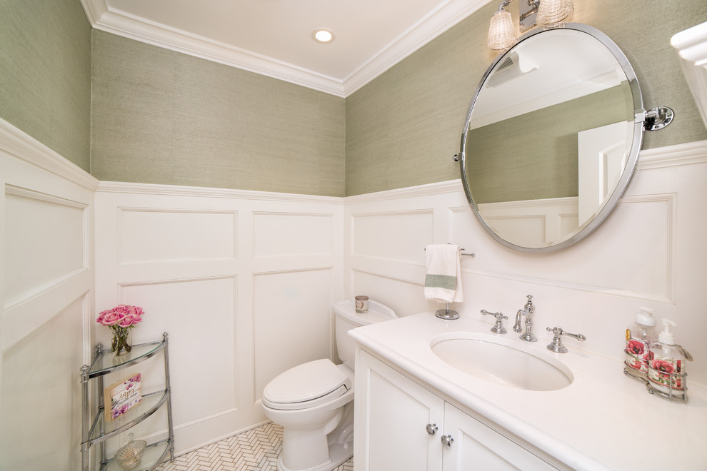 Design ideas for a small country powder room in New York with beaded inset cabinets, white cabinets, a two-piece toilet, green walls, mosaic tile floors, an undermount sink, engineered quartz benchtops, white floor and white benchtops.